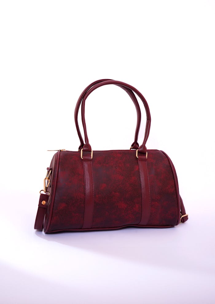 heros-img Stylish burgundy handbag perfect for fashion and accessories. Ideal for studio shoots.