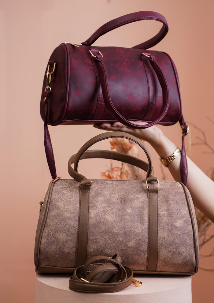 Two stylish handbags beautifully displayed in a retail setting, showcasing elegance and fashion.